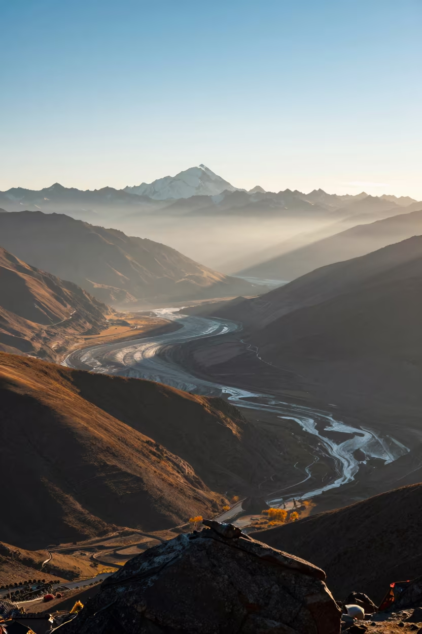 Dawn Light Over Glacial Valley Near Lhasa in from a ridge above layered foothills near Lhasa