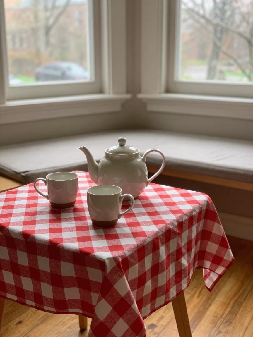 Dawn Light on Teapot and Mismatched Mugs in on a reading nook cushion in Kingston