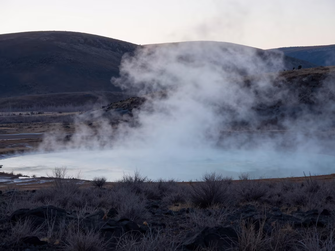 Dawn Mist Over Volcanic Hot Lake Ridge in from a ridge above layered foothills in Colorado