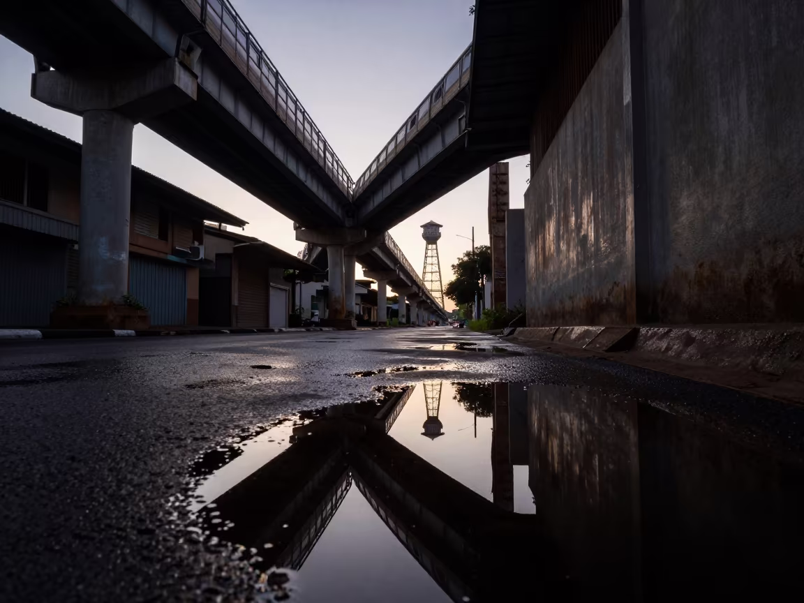 Dawn Reflection of Water Tower in Douala Alley in under an elevated train line in Douala