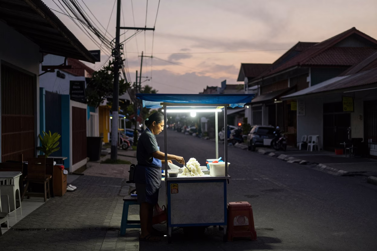 Dawn Street Food Vendor in Denpasar Indonesia Preparing Condensed Milk Shaved Ice in in Denpasar, Indonesia