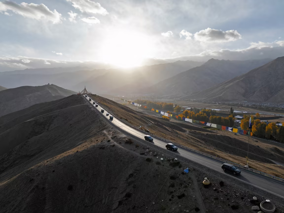 Dawn Traffic on Leh Causeway Ridge Aerial in on a wind-cut ridge below prayer flag lines near Leh