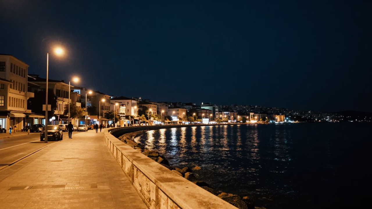 Deep Night View of Izmir Kordon Promenade with Vintage Junk Boat Anchored in Harbor in in Izmir, Turkey