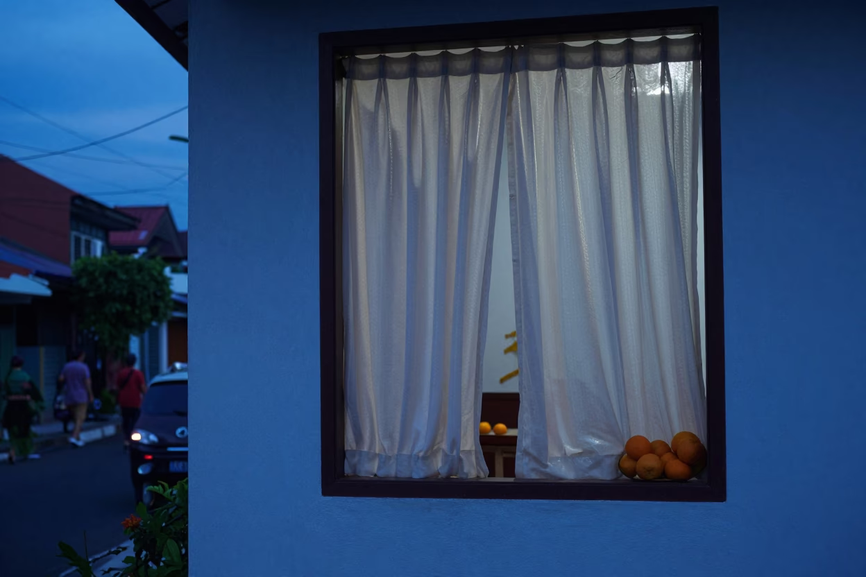 Denpasar Indonesia Evening Street Scene with Curtains and Oranges in Indigo Twilight in in Denpasar, Indonesia