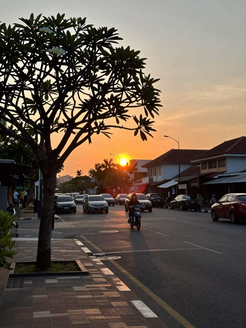 Denpasar Indonesia Sunset Horizon Street Scene with Plumeria Tree and Local Life in in Denpasar, Indonesia