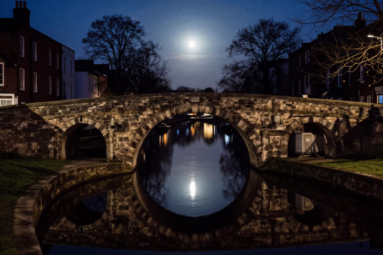 Devils Bridge Midnight Reflection Circle in beside a canal-front facade in United Kingdom
