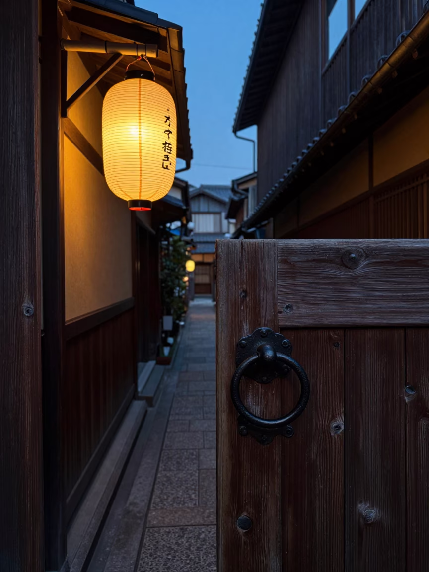 Dimly lit traditional wooden gate handle in narrow Osaka alley before dawn in in Osaka, Japan