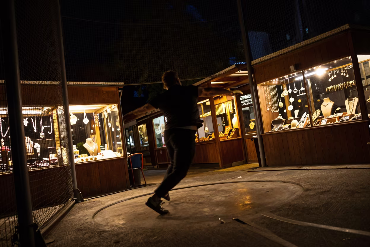 Discus Thrower Spinning in Bazaar Firelight in at a jewelry counter inside a covered bazaar in Guelph