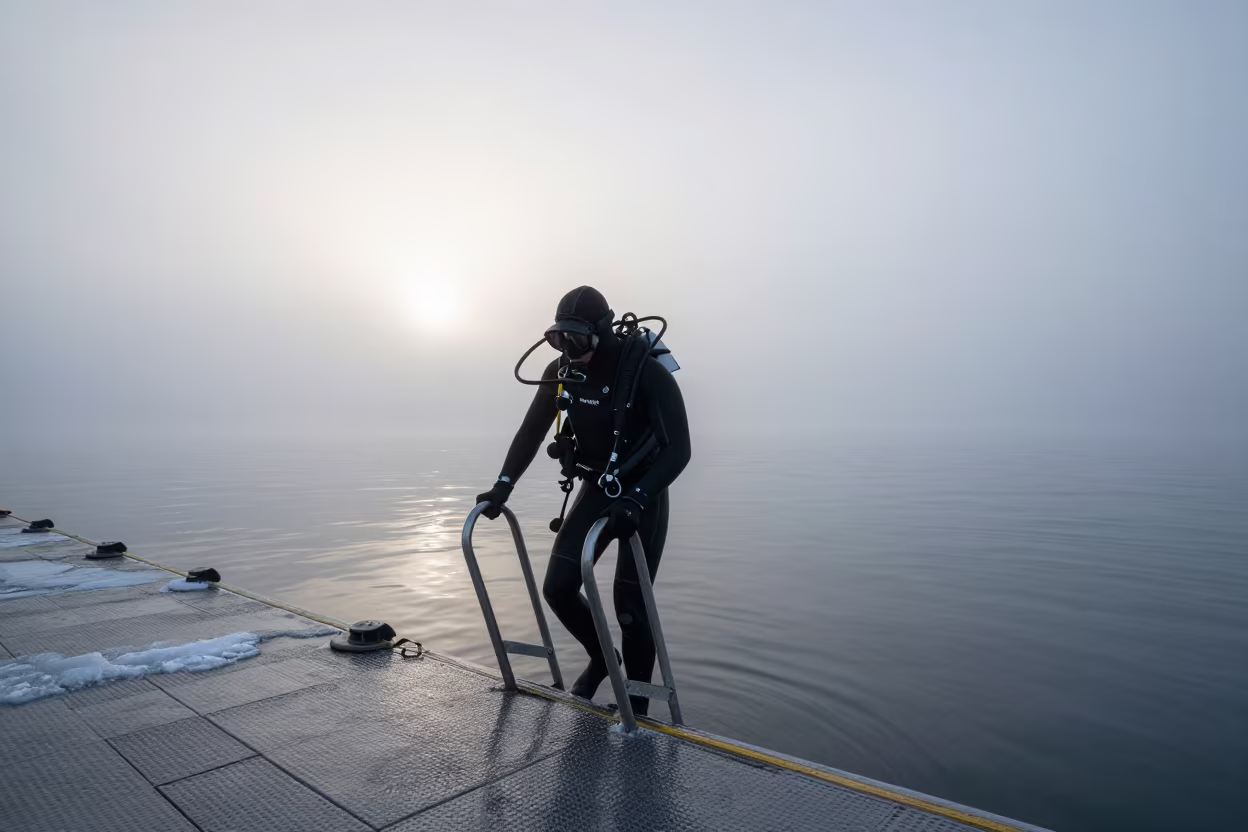 Diver Entering Winter Waters at Dawn in near Gothenburg