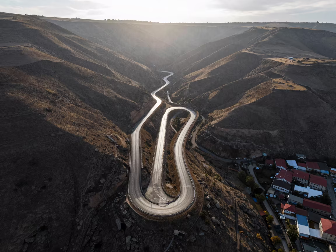 Drone View Switchback Roads Copper Hills in high above patterned rooftops near Kayseri