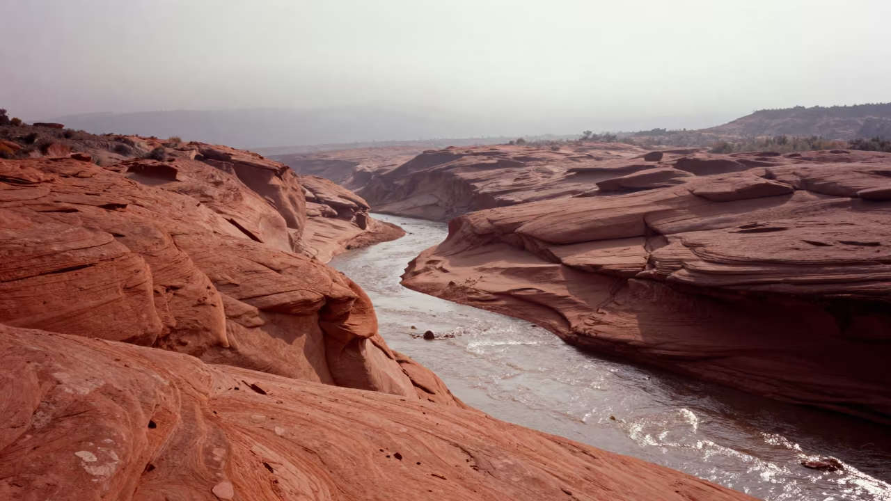 Dry Wadi Cutting Through Red Sandstone in Liguria in from a ridge above layered foothills in Liguria