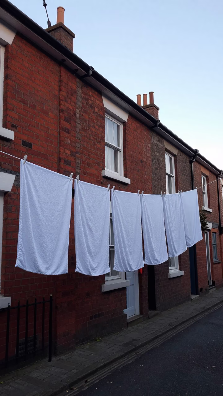 Drying Towels Hanging on Line Outside Brick Row House in Liverpool Before Dawn in in Liverpool, United Kingdom