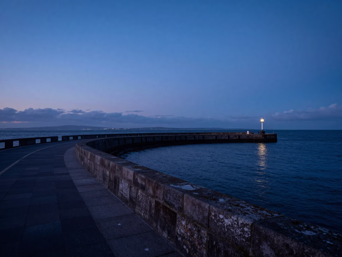 Dublin Harbor Twilight View of Breakwater Curve Leading to Lonely Harbor Beacon in Ireland in in Dublin, Ireland
