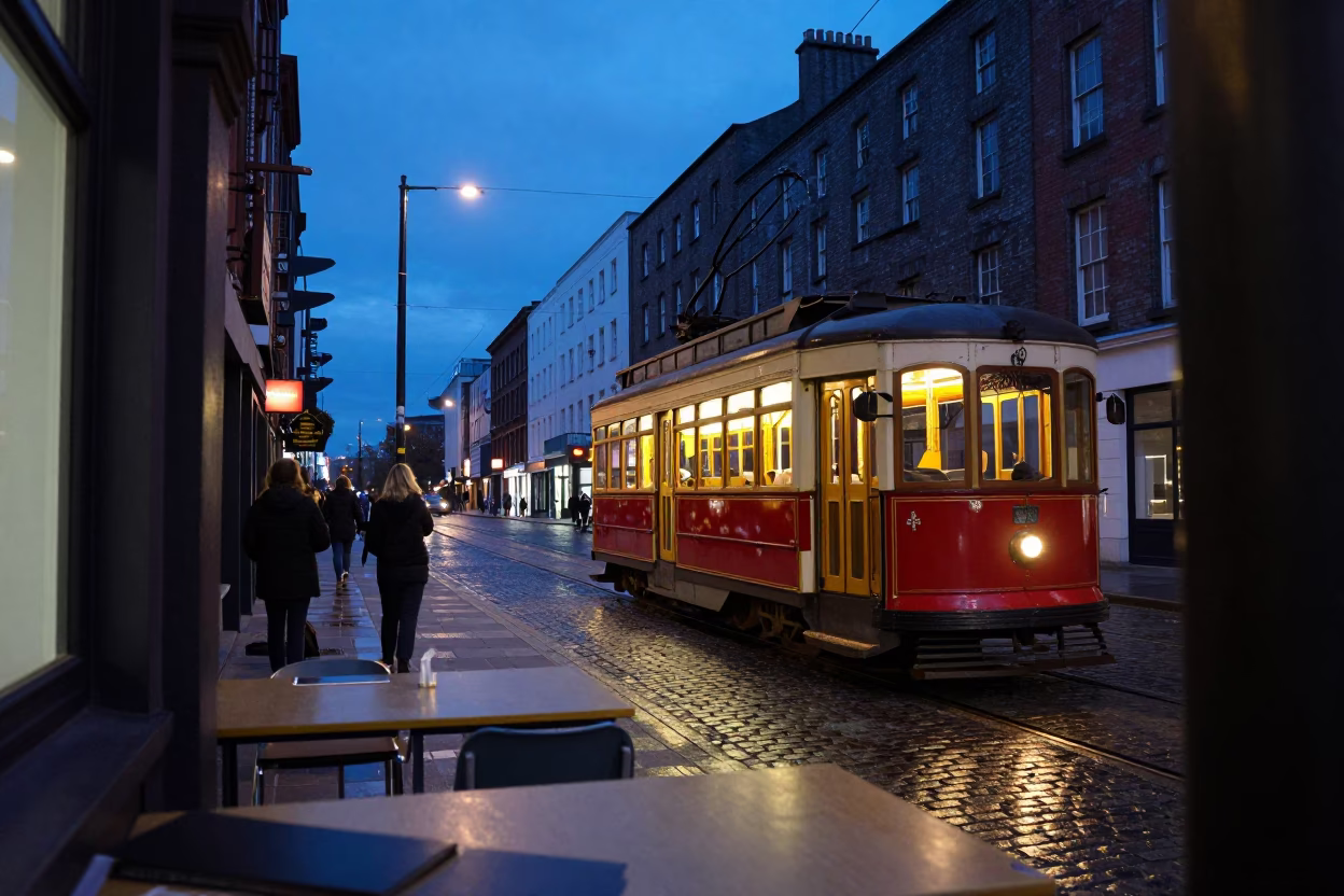 Dublin Ireland indigo twilight heritage tram on cobblestone avenue with classroom window condensation in in Dublin, Ireland