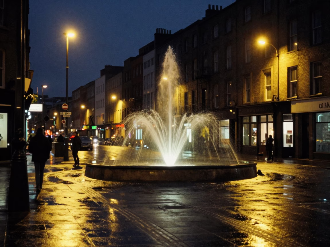 Dublin Ireland Midnight Street Scene with Fountain Spray and Window Light Reflections in in Dublin, Ireland