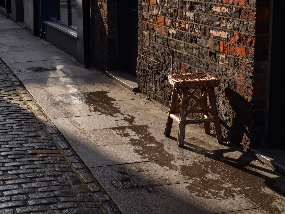 Dublin Late Afternoon Street Scene with Wicker Stool Shadow and Enamel Pitcher on Cobblestone in in Dublin, Ireland