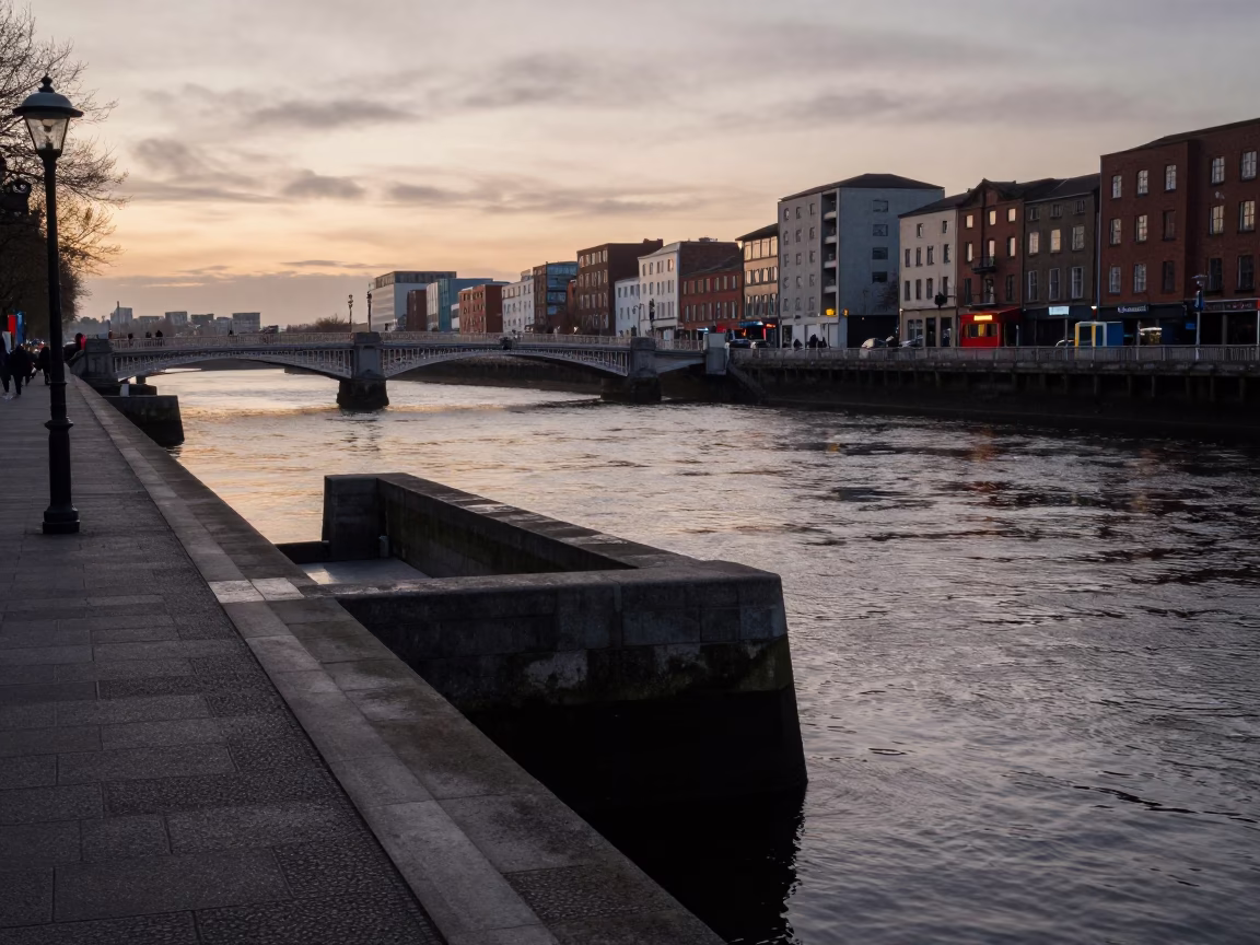 Dublin Liffey Riverbank at Dawn with Bridge Pier and Still Water Reflections in in Dublin, Ireland