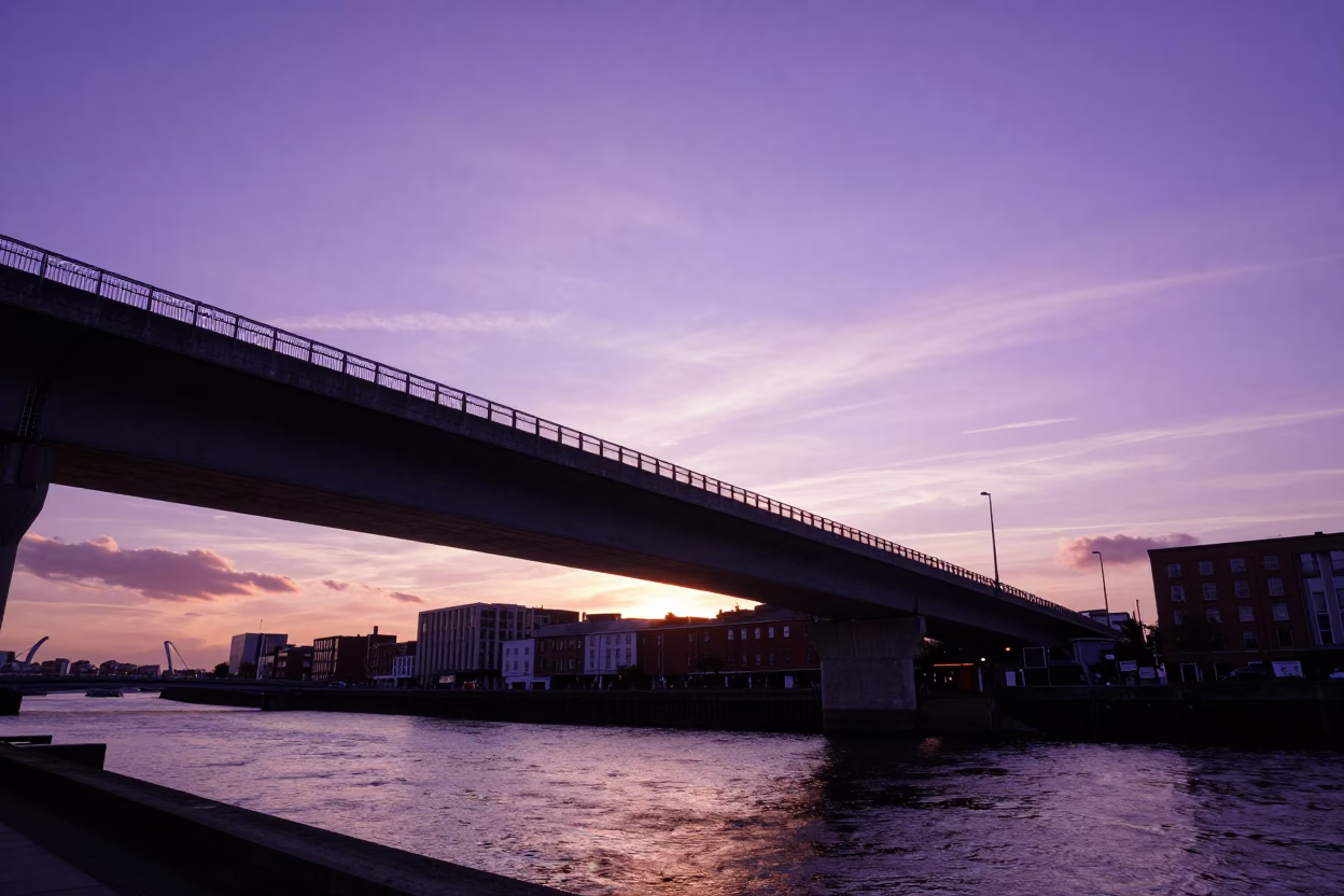 Dublin Sunset View Over Liffey Quays with Violet Sky and Urban Bridge Silhouette in in Dublin, Ireland