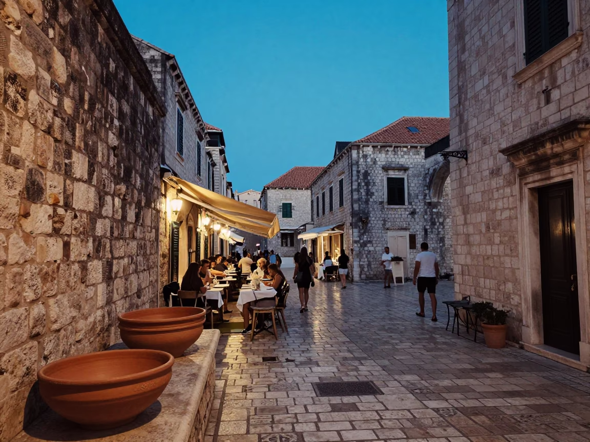 Dubrovnik Evening Street Scene with Terracotta Bowls and Local Dining in in Dubrovnik, Croatia