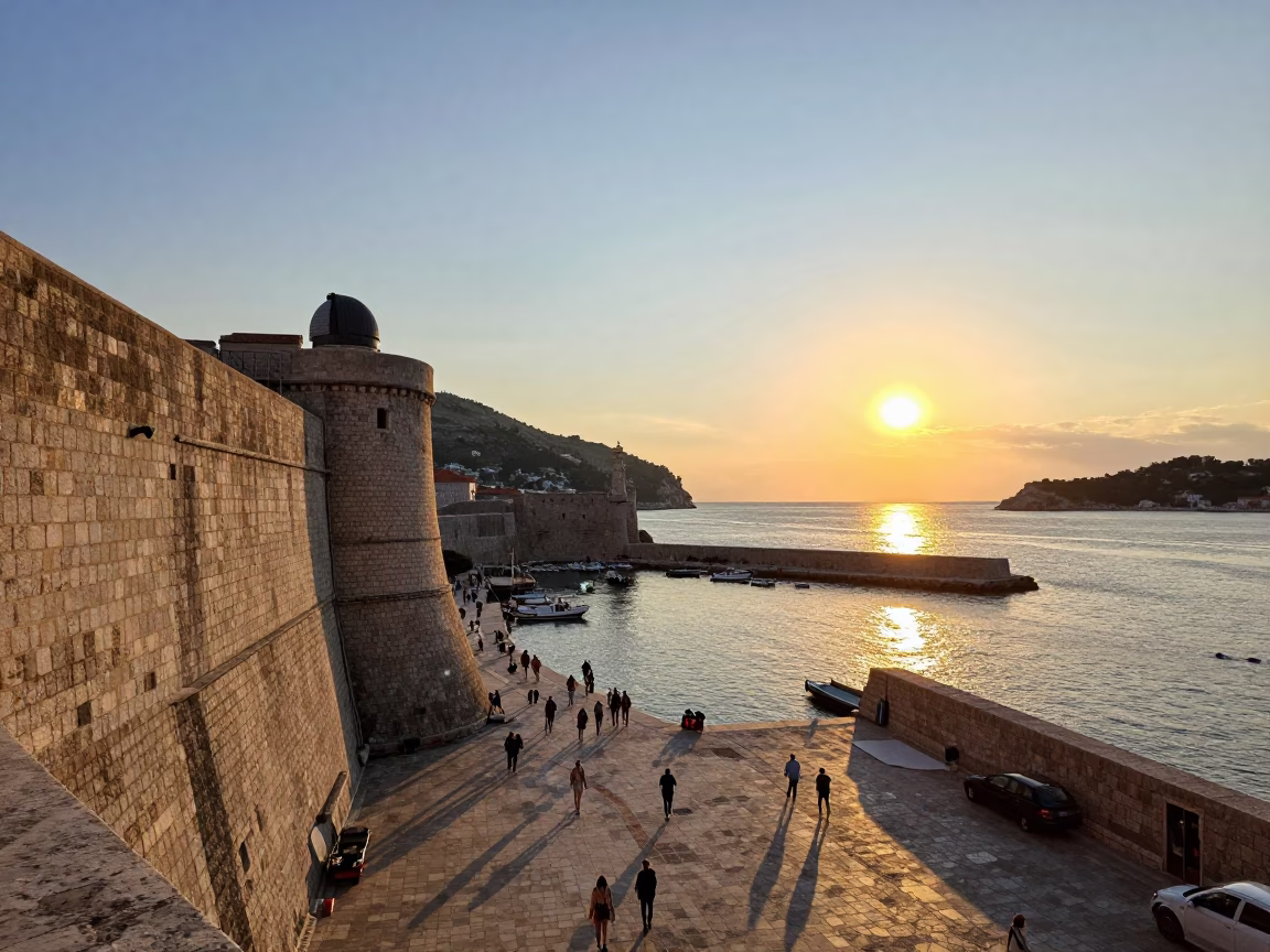 Dubrovnik Harbor Sunset with Breakwater Beacon and Local Street Activity in in Dubrovnik, Croatia