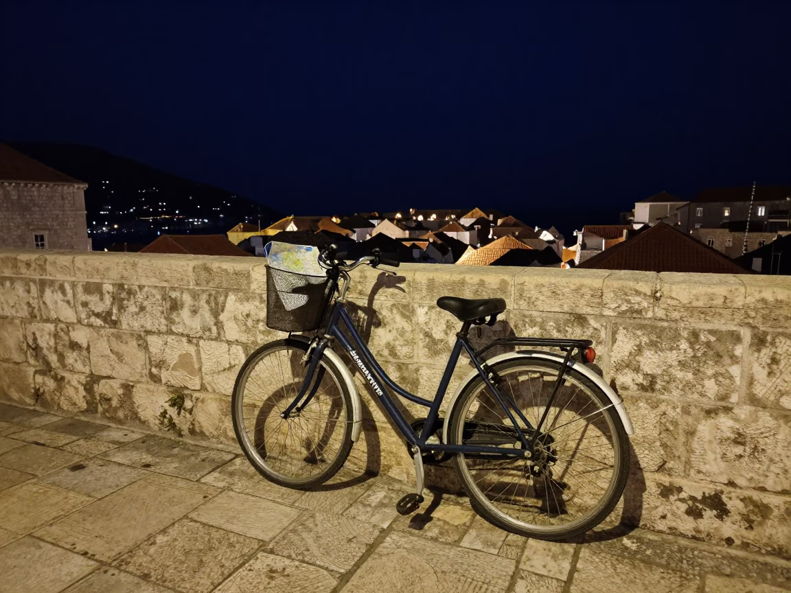 Dubrovnik Night Street Scene with Bicycle Basket and Stone Walls in in Dubrovnik, Croatia