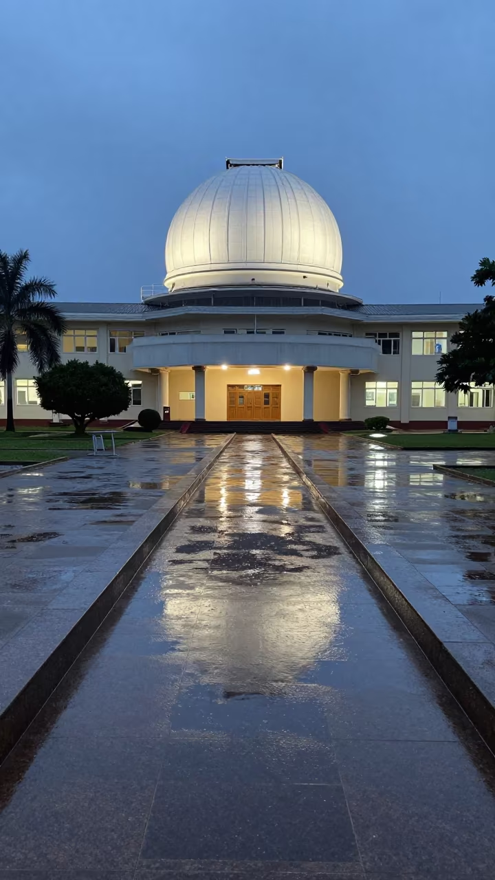 Dusk Observatory Dome Reflected in Rain in across a rain-washed campus courtyard in Conakry