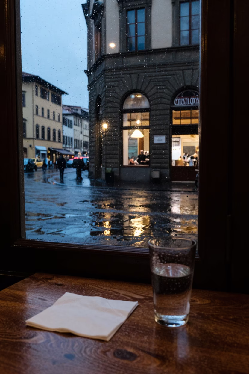 Dusk Rain Reflections on Florentine Street Corner Cafe Table in in Florence, Italy
