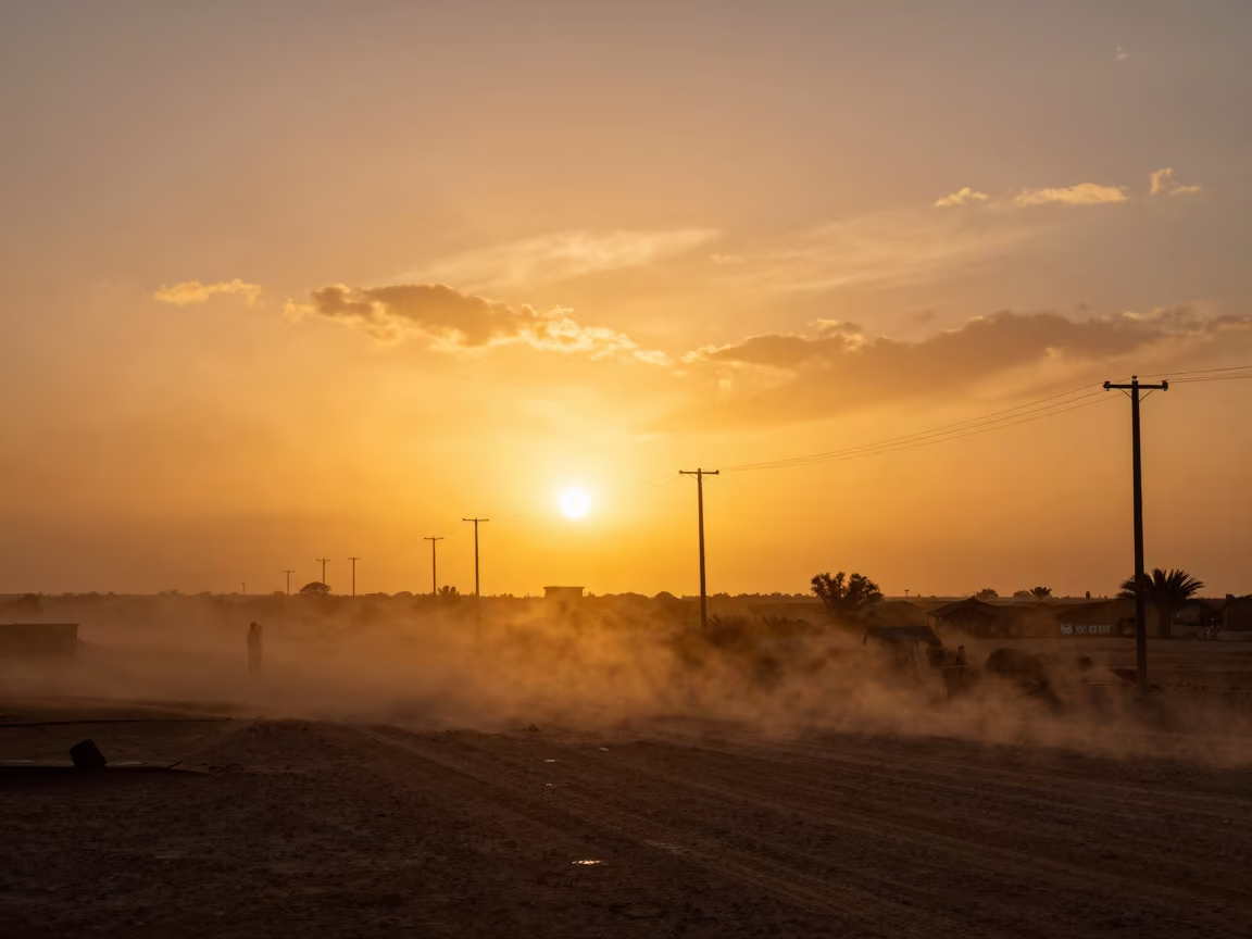 Dusty Sunset Silhouettes Against Mauritania Clouds in beneath fast-moving cloud bands in Mauritania