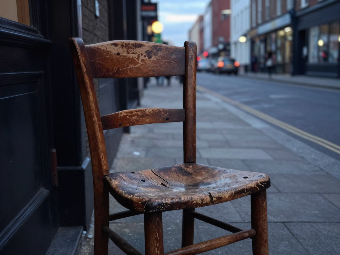 Early Evening Dublin Street Scene with Worn Wooden Chair and Urban Details in in Dublin, Ireland