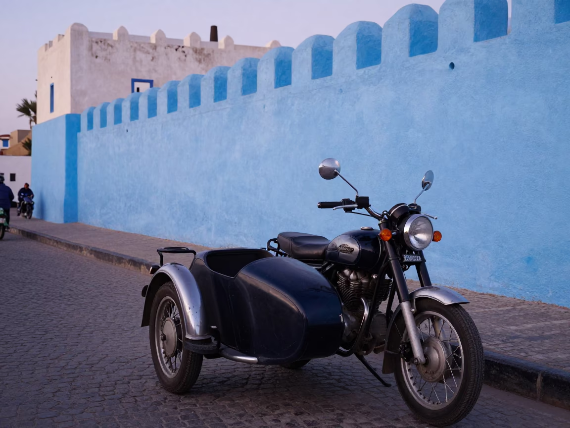 Early Evening Street Scene in Essaouira Morocco with Vintage Motorcycle and Linen Fringe in in Essaouira, Morocco
