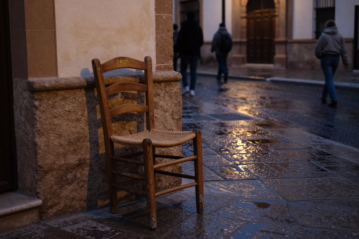 Early Evening Street Scene in Granada Spain with Ladder-Back Chair and Water Stains in in Granada, Spain