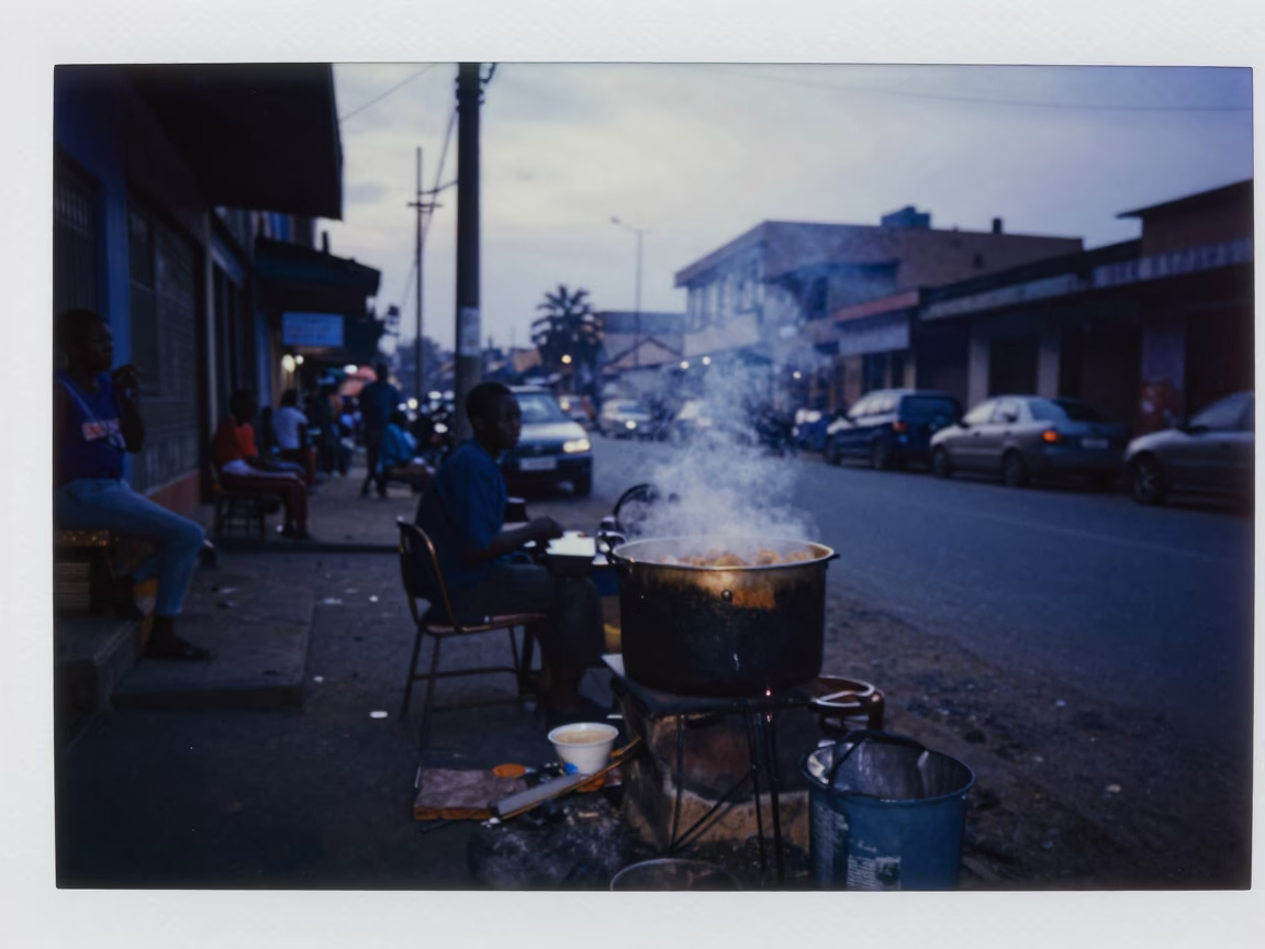 Early Morning Accra Street Scene with Charcoal Stove and Wooden Bench Before Dawn in in Accra, Ghana