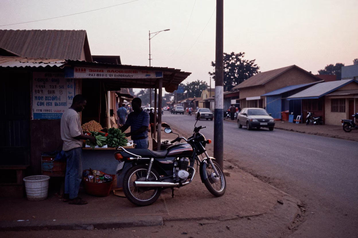 Early Morning Accra Street Scene with Motorcycle and Local Market Activity Before Dawn in in Accra, Ghana