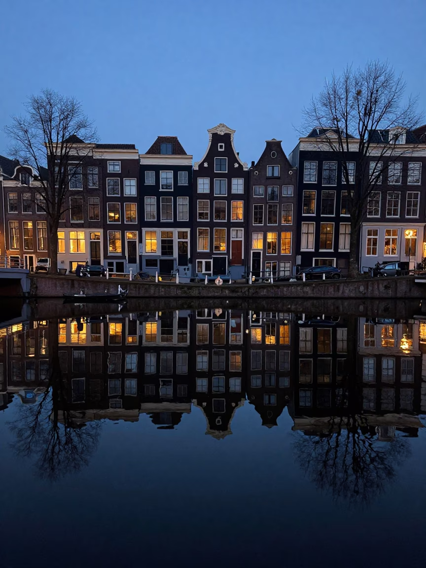 Early Morning Amsterdam Canal Reflections with Glass Bottles and Blossoming Magnolia Tree in in Amsterdam, Netherlands