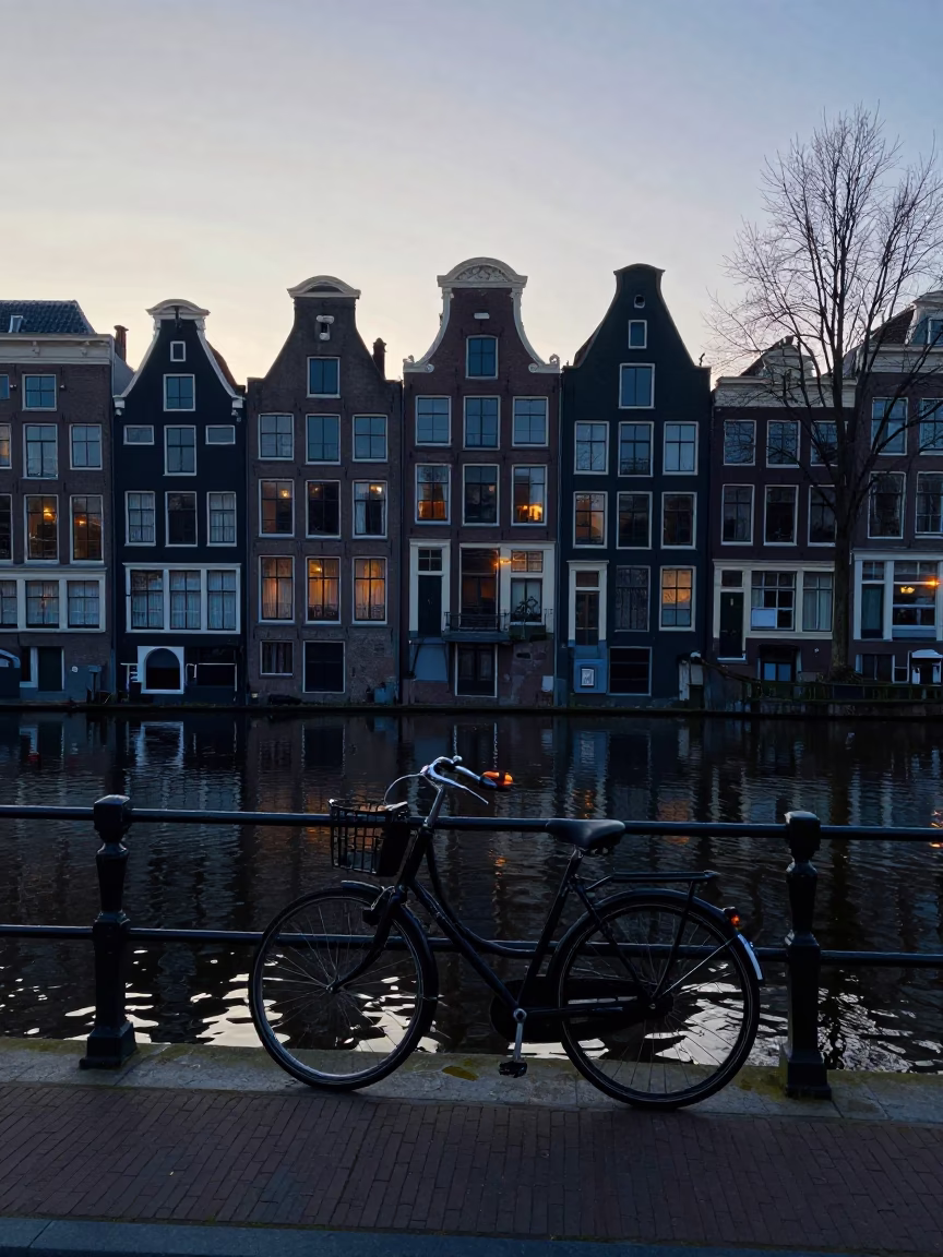 Early Morning Amsterdam Canal Scene Before Sunrise with Bicycle and Brick Architecture in in Amsterdam, Netherlands