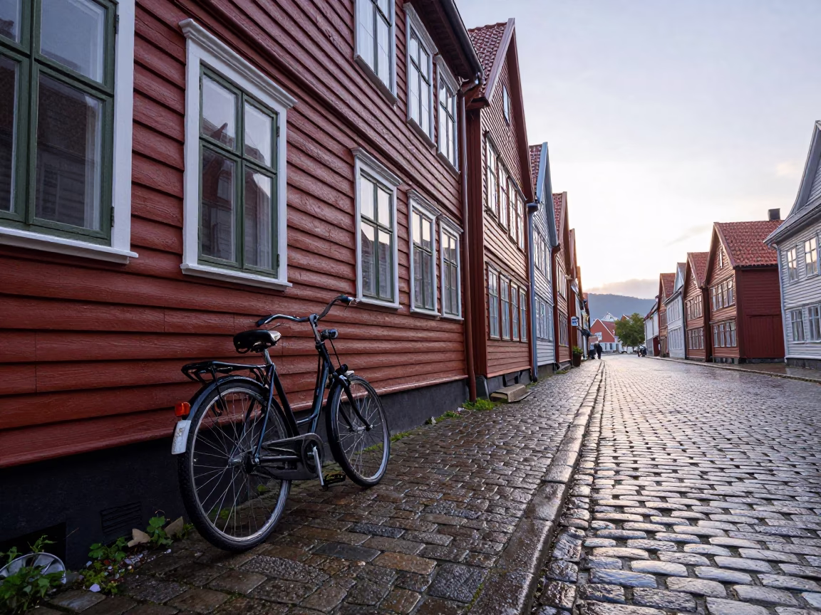 Early morning Bergen Norway cobblestone street scene with vintage bicycle and wet stone architecture in in Bergen, Norway