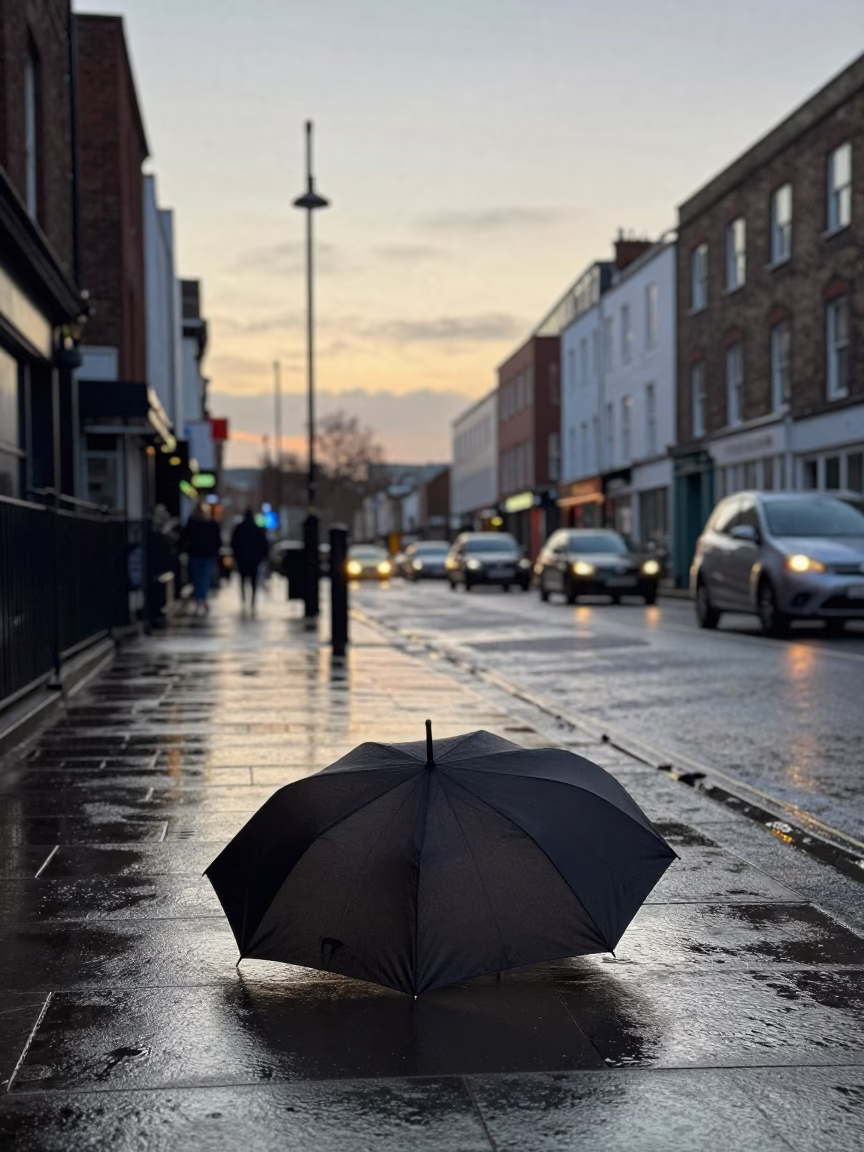 Early Morning Bristol Street Scene with Forgotten Umbrella and Wet Pavement Reflections in in Bristol, United Kingdom