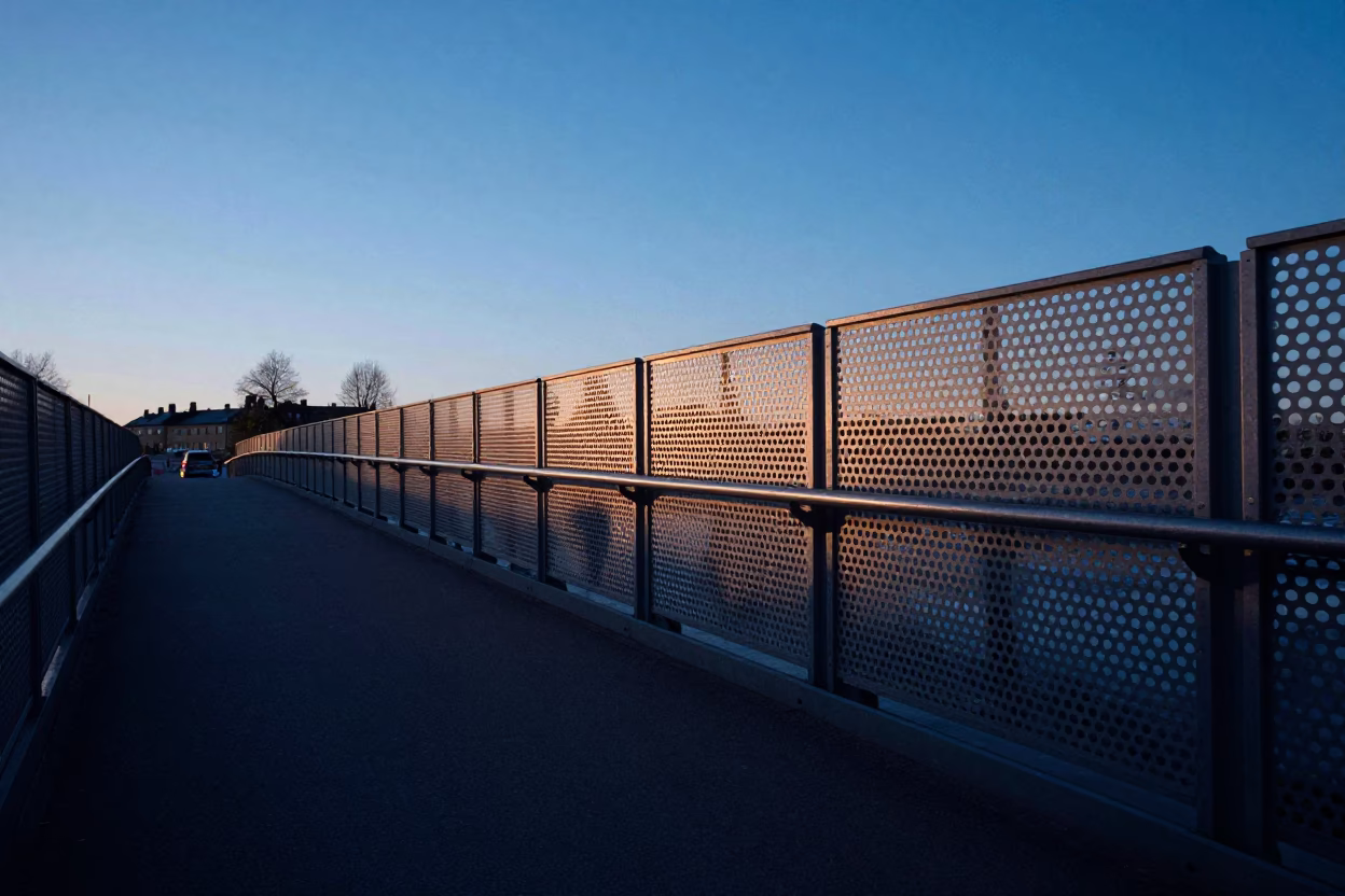Early Morning Commute Over Perforated Metal Bridge in Stockholm Before Sunrise in in Stockholm, Sweden