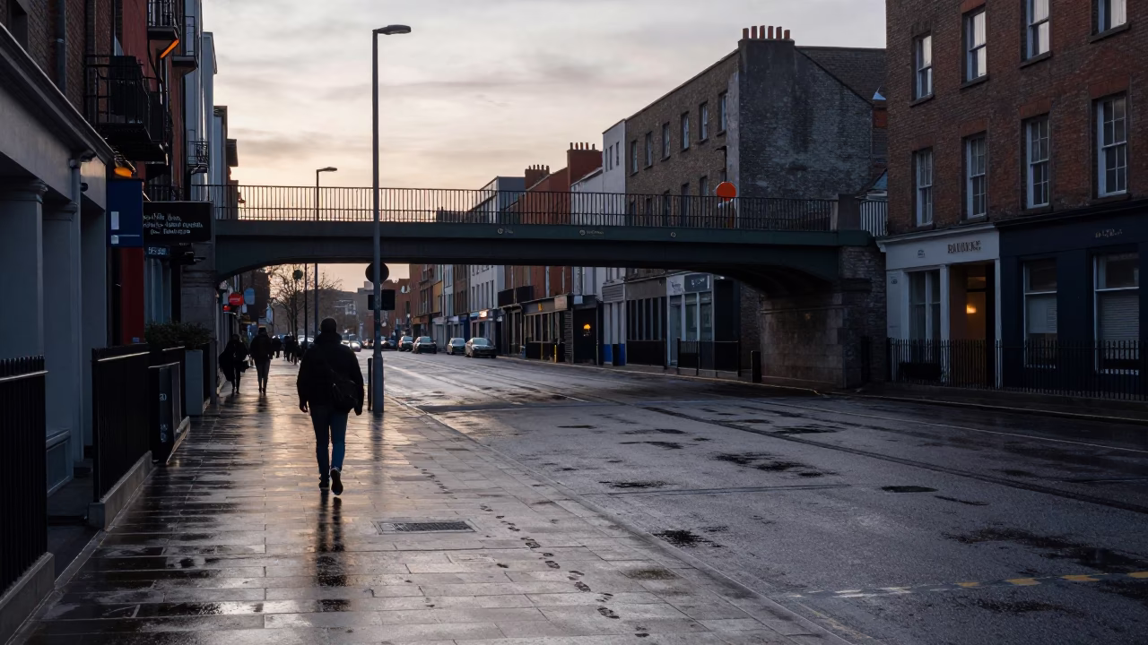 Early Morning Dublin Street Scene with Pedestrian Overpass and Wet Footsteps on Perforated Metal in in Dublin, Ireland