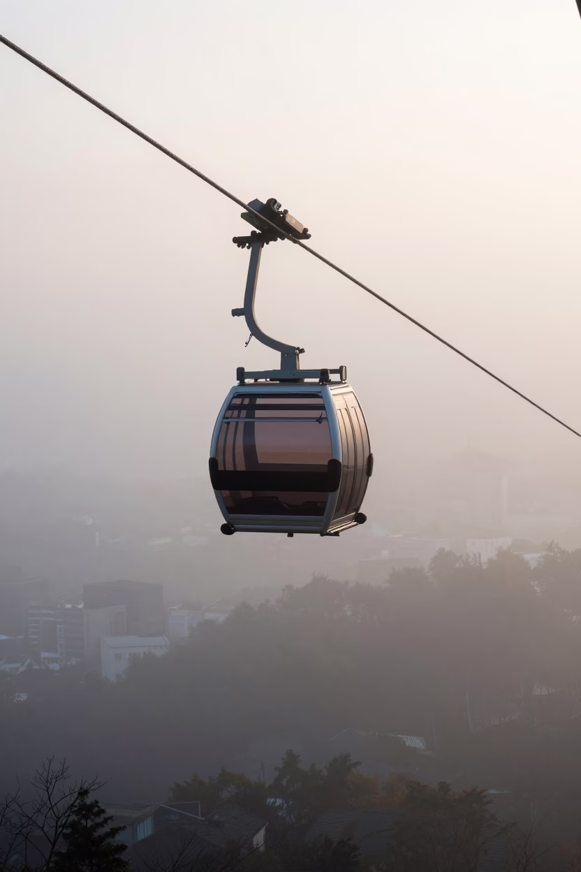 Early Morning Fog and Aerial Tramway Gondola Over Fukuoka Cityscape in in Fukuoka, Japan