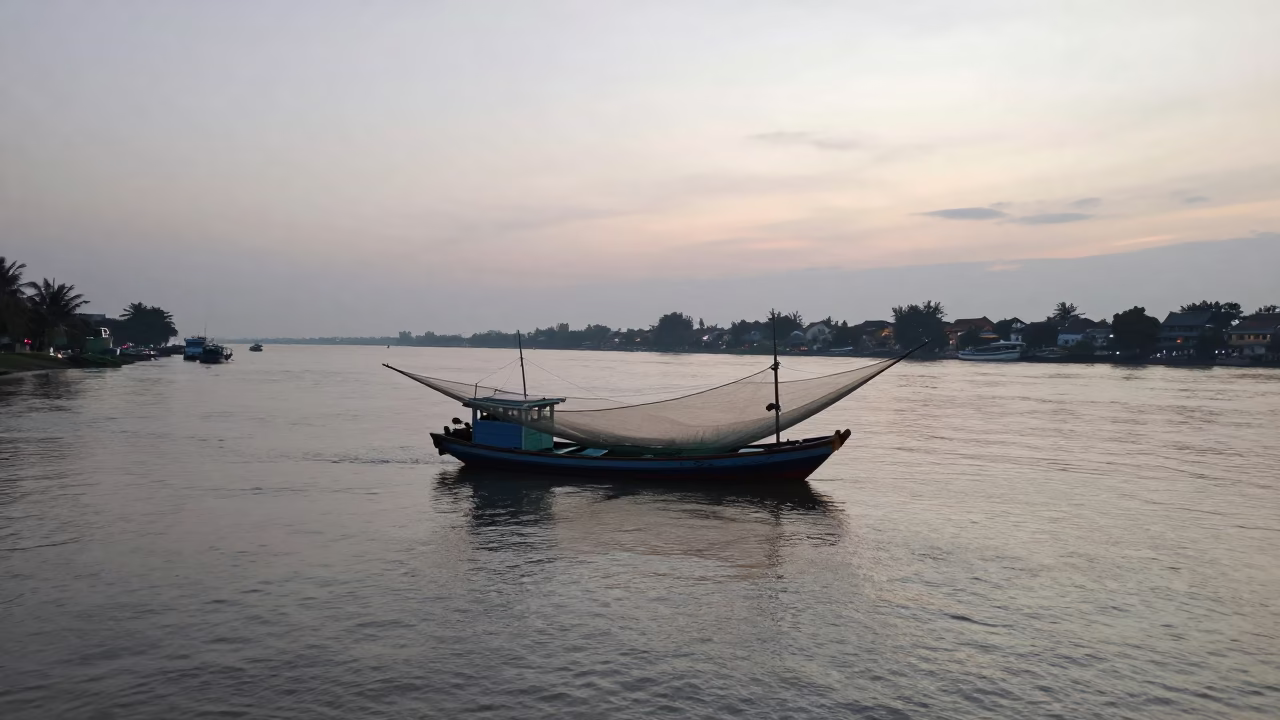 Early Morning Hoi An Vietnam River Scene with Shrimp Trawler Nets and Yellow Facades in in Hoi An, Vietnam
