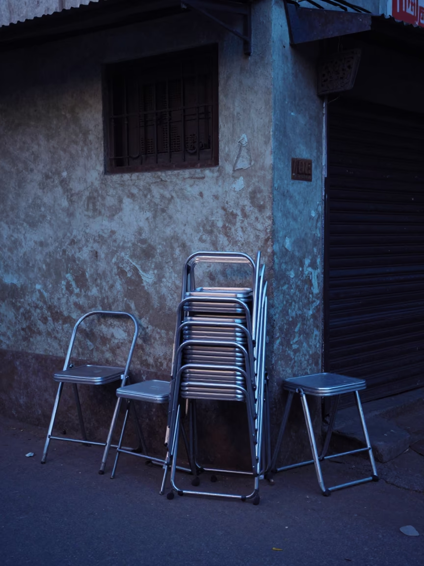 Early Morning Hyderabad Street Scene with Folding Stools and Local Commerce Before Dawn in in Hyderabad, India
