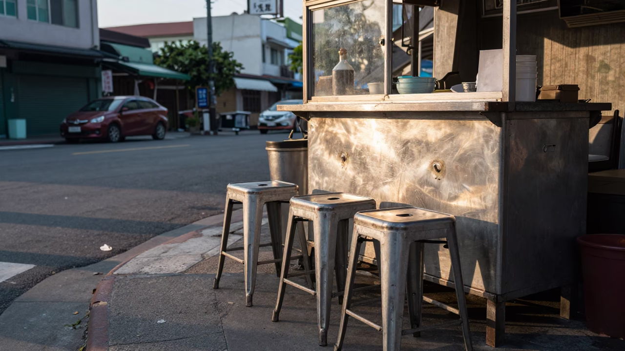 Early Morning Kaohsiung Street Scene with Metal Stools and Local Commerce in in Kaohsiung, Taiwan