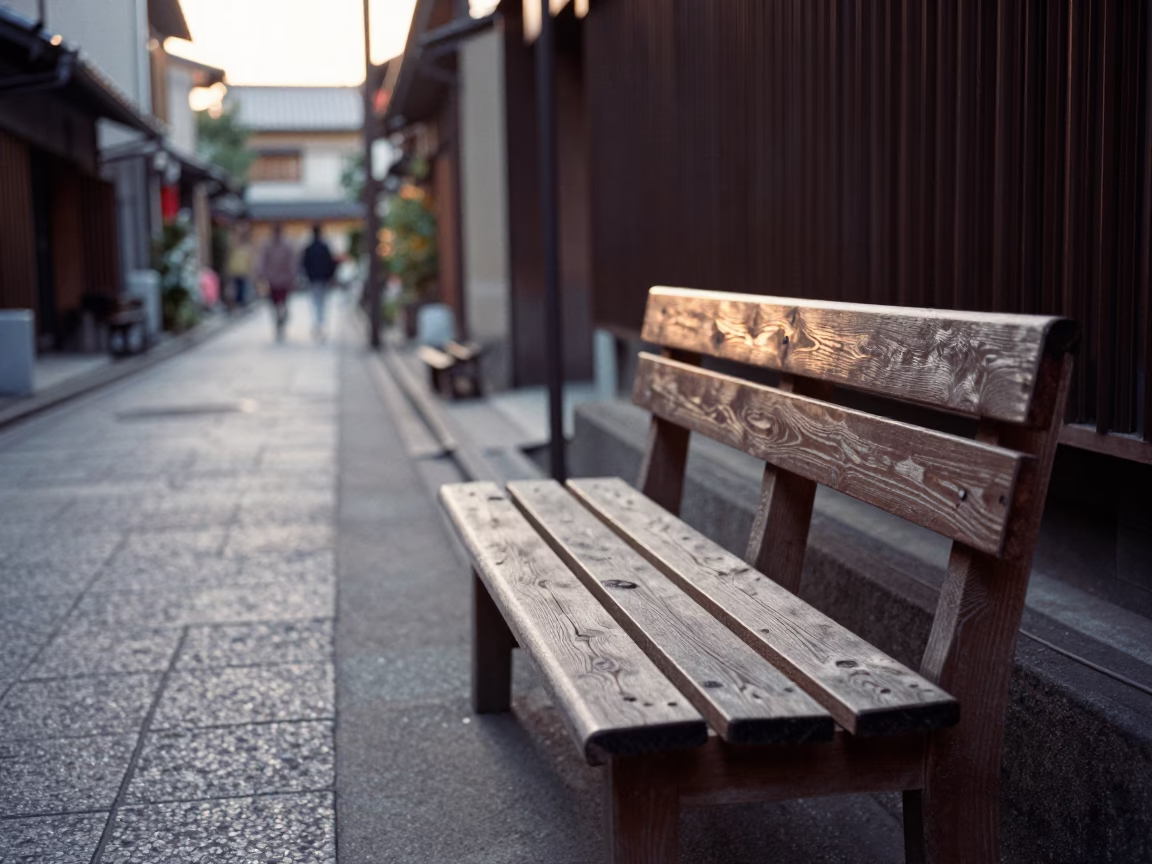 Early Morning Kyoto Street Scene with Wooden Slatted Bench and Water Droplets in in Kyoto, Japan