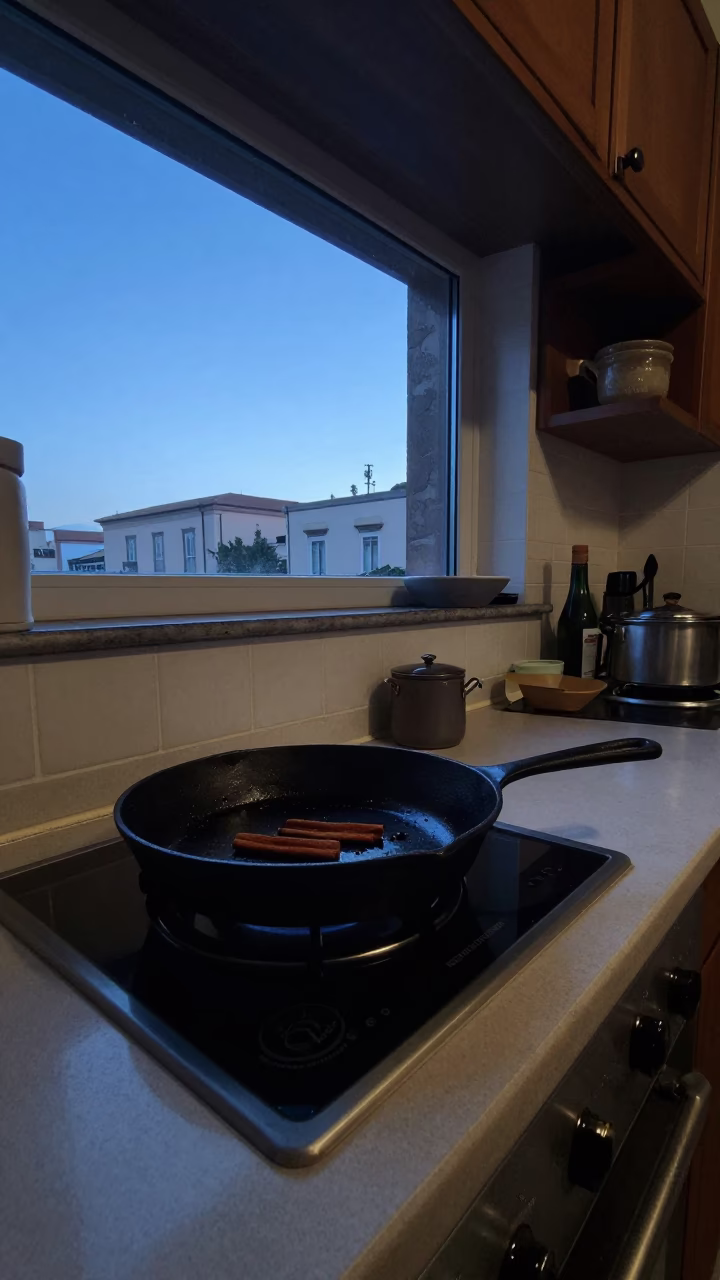 Early morning Naples kitchen scene with skillet and cinnamon rolls before dawn in in Naples, Italy