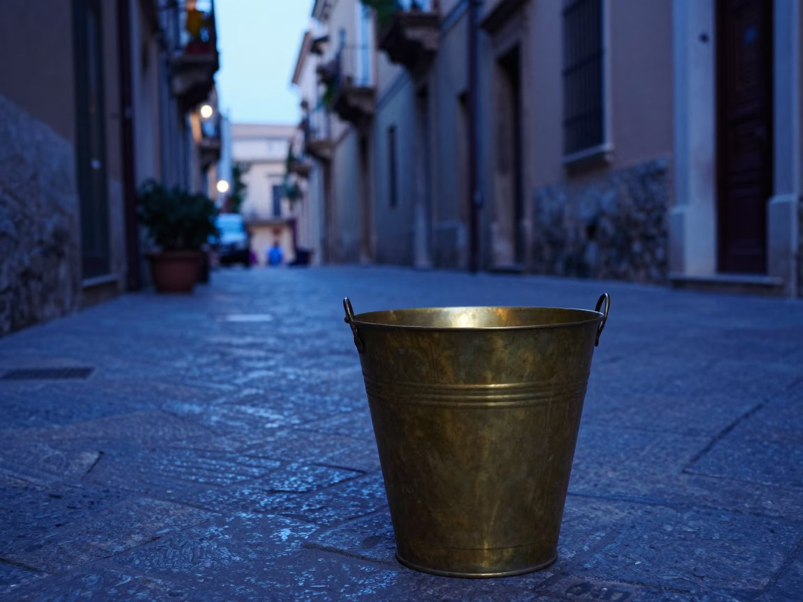 Early morning Palermo street scene with brass bucket and ceramic plate in in Palermo, Italy