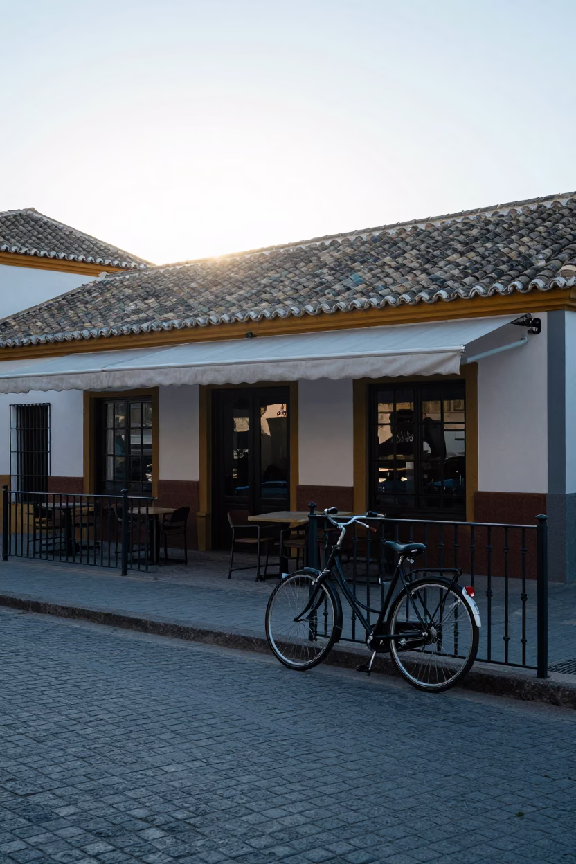 Early Morning Seville Spain Street Scene with Bicycle Leaning Against Cafe Exterior in in Seville, Spain