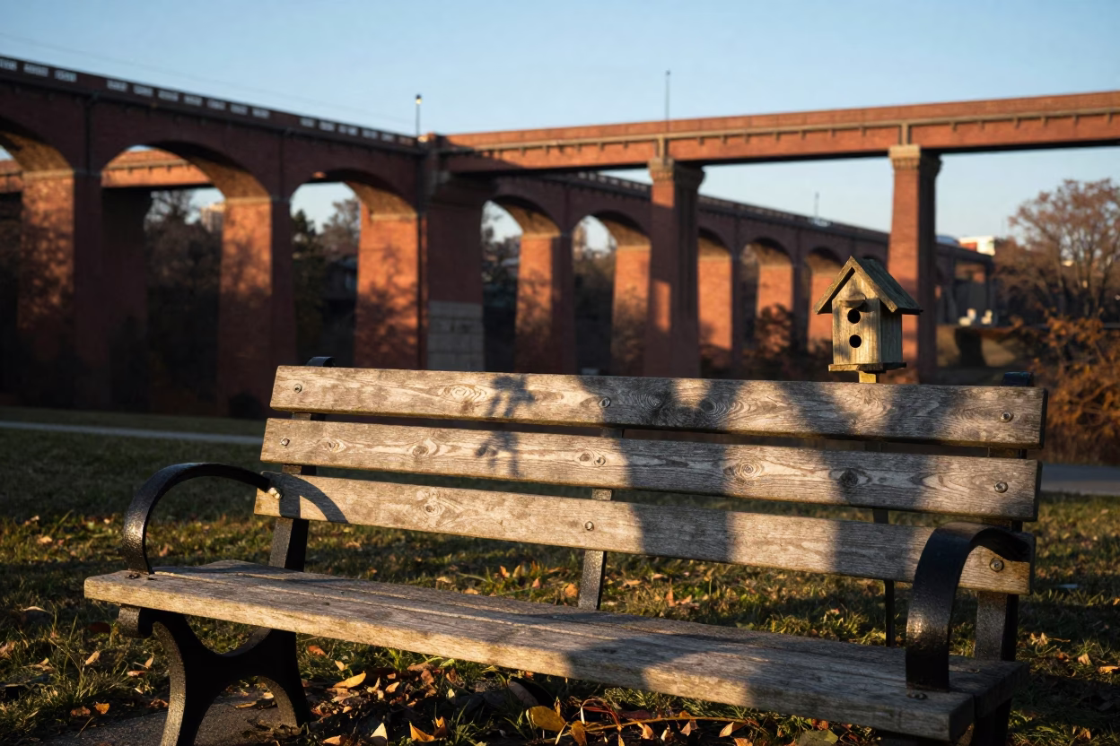 Early Morning Sunlight on Philadelphia Park Bench with Birdhouse and Railway Viaduct in in Philadelphia, Pennsylvania, United States