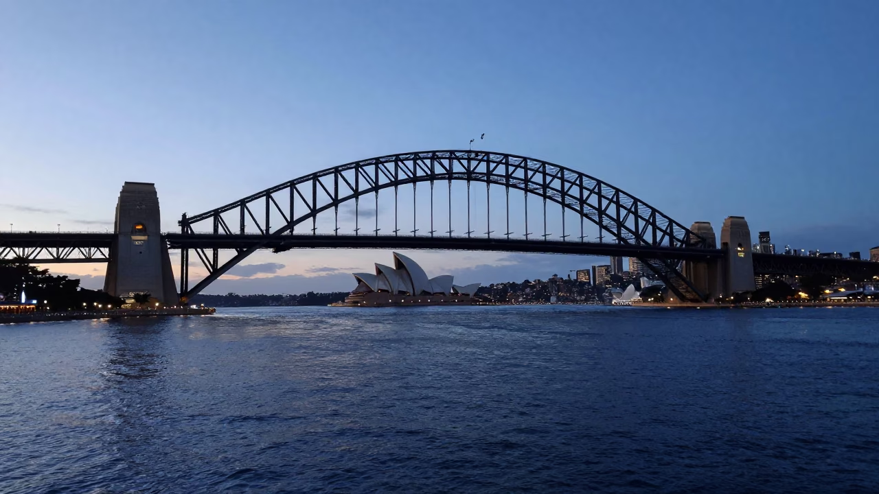 Early Morning Sydney Harbour Bridge and Circular Quay Before Sunrise with Cyclists and Ferry in in Sydney, New South Wales, Australia