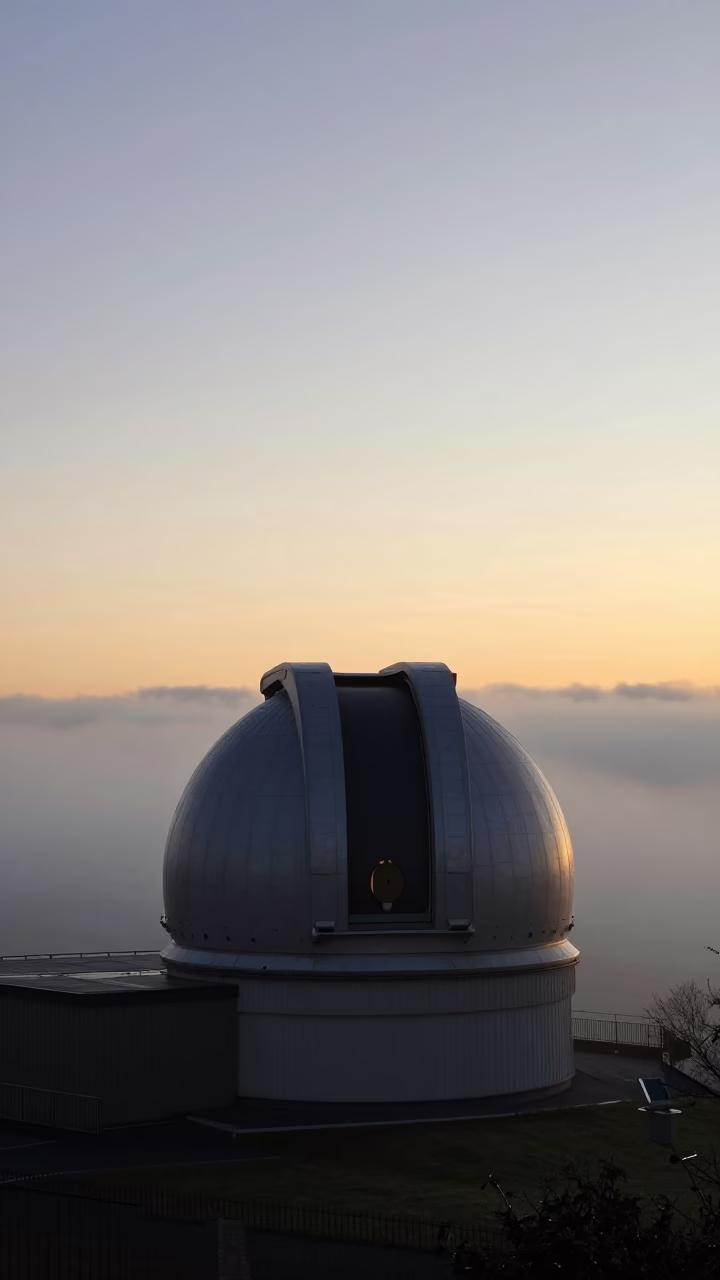 Edinburgh Nautical Dawn Observatory Dome Silhouette Above Drifting Ground Fog and Telescope Counterweight in in Edinburgh, United Kingdom